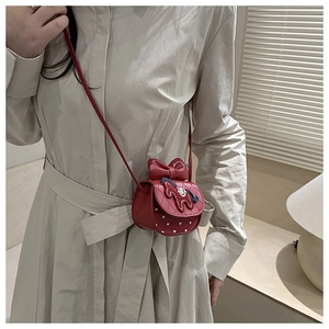 Detail of red girls mini crossbody bag with leather bow and colorful pony embroidery