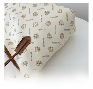 Macro shot of grainy faux leather tote bag with floral print and brown leather trim