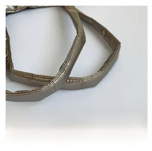 Detail of champagne gold quilted straps with metallic finish and padded stitching