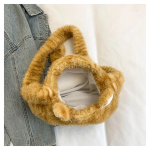 Macro detail of plush orange striped cat tote bag with cute ears and white lining