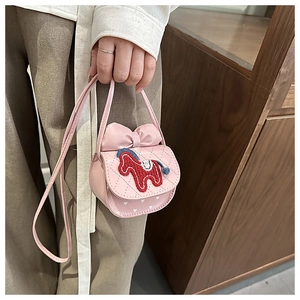 Close-up of pink quilted crossbody bag with 3D bow and pony embroidery for girls