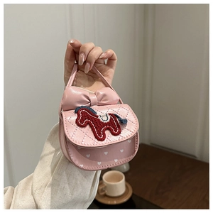 Detailed macro view of quilted pink mini crossbody bag with cute horse embroidery