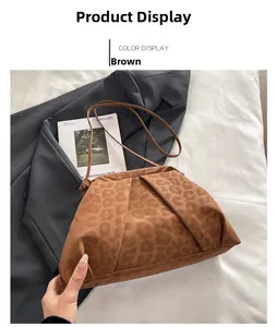 Detailed view of leopard print shoulder bag with pleated texture on suede fabric