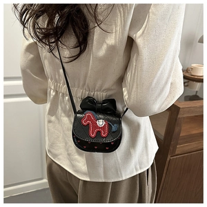 Detail of a mini black quilted leather crossbody bag with bow and pony embroidery