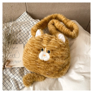 Detailed close-up of fluffy orange tabby cat plush shoulder bag with cute fuzzy ears