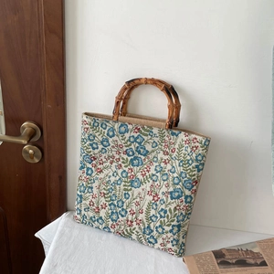 Floral jacquard tote bag featuring natural bamboo handles in a vintage spring style