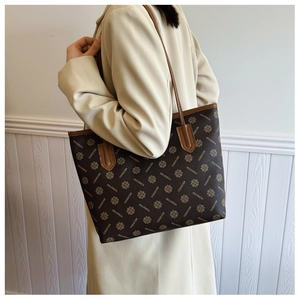 Detail shot of vintage patterned tote bag with brown geometric print and long shoulder straps