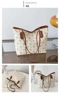 Detailed close-up of a large floral tote bag with brown leather trim and retro pattern