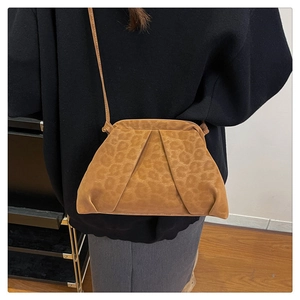Detail view of brown leopard print pleated cloud bag with soft suede-like texture