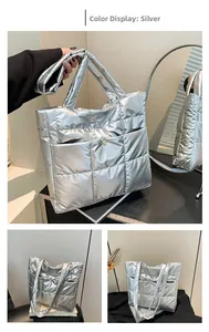 Detail view of silver quilted tote bag with metallic finish and front buckle pocket