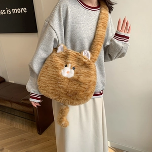 Cute ginger tabby cat plush tote bag with 3D ears and tail in cozy indoor setting