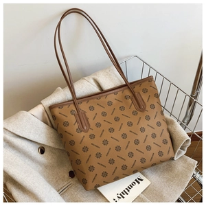 Close-up of brown tote bag with logo pattern placed inside a metal shopping cart