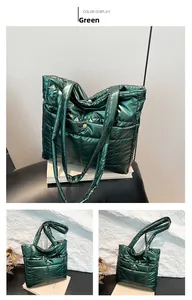 Macro detail of green quilted down tote bag showing metallic luster and square stitching