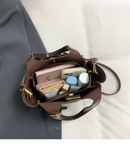 Macro top view of brown matte tote bag interior showing ample storage for daily essentials