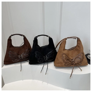 Three large capacity suede hobo bags with butterfly appliques and lace-up details