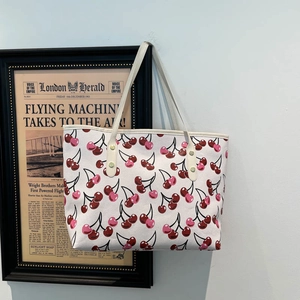 Chic large capacity white tote bag with red cherry prints and sturdy gold rivets