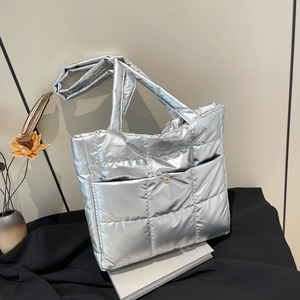 Silver metallic quilted puffer tote bag with large capacity and golden buckle closure