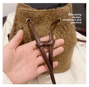 Detail of the brown wool backpack with adjustable leather drawstring and metal eyelets