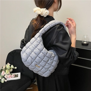 Light gray quilted cloud bag with gold metal plaque and wide shoulder strap