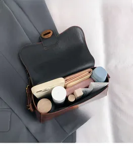 Detail view of the spacious inner compartment of this vintage brown leather handbag