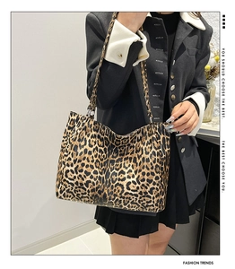 Detail view of large leopard print tote bag paired with a stylish black blazer outfit