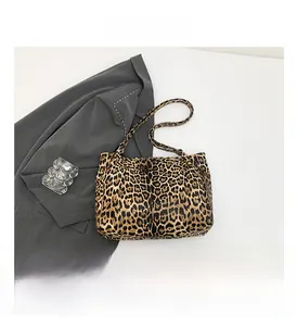 Detail view of large leopard print tote bag placed on a grey blazer for a stylish look
