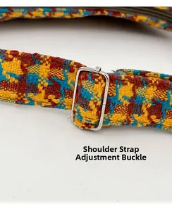 Detail of bohemian woven strap with adjustable metal buckle on plaid shoulder bag
