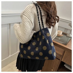 Winter navy tote bag with olive green polka dots and braided rope shoulder strap detail