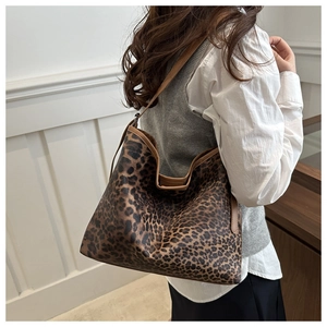 Leopard print tote bag styled with a white outfit in a minimalist room interior