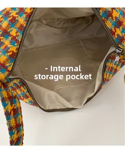 Detail view of colorful plaid bag interior with fabric lining and open storage pocket