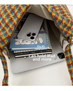 Top view of spacious plaid crossbody bag showing internal capacity for tablets and books
