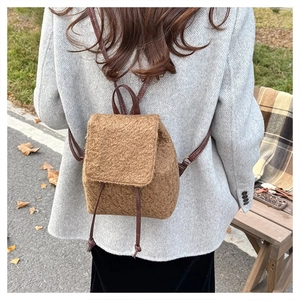 Detailed view of brown plush wool backpack with drawstring closure and slim straps