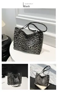 Detailed close-up showing the leopard print texture and spacious interior of the tote bag