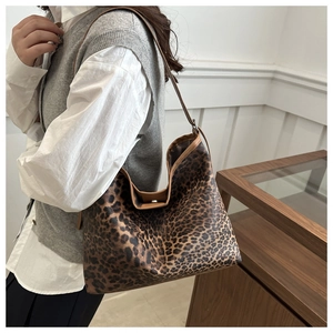 Hobo leopard print tote bag with brown leather straps and metal magnetic closure