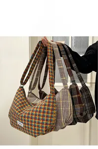 Detail shot of vintage plaid canvas hobo bags in various retro color patterns