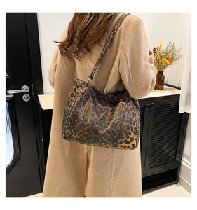 Detailed back view of a chic leopard print tote bag styled in a cozy autumn interior