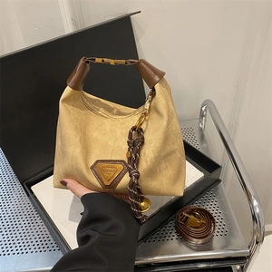 Minimalist light brown canvas hobo bag with leather trim and dual adjustable straps