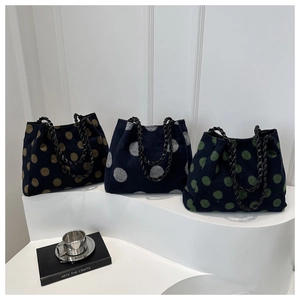 Three fluffy polka dot tote bags in navy blue with brown, gray, and green dots and metal chains
