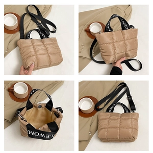 Detailed view of beige quilted puffer tote with branded handles and detachable shoulder strap