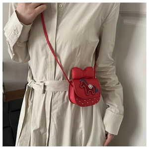 Detail shot of mini red crossbody bag for girls featuring a cute pony patch and large bow