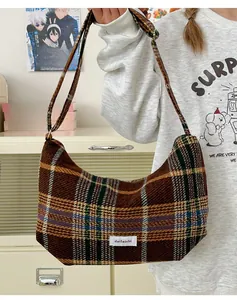 Retro brown plaid underarm bag in wool texture shown on model in a casual home setting