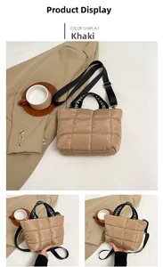 Detail of khaki quilted puffer tote bag with lettered handles and adjustable strap
