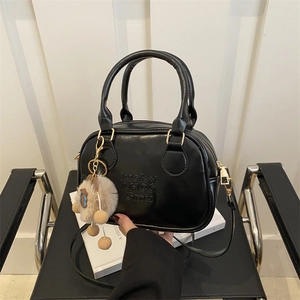 Retro black glossy square handbag with plush ball pendant and adjustable shoulder strap
