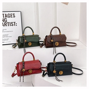 Detail view of retro crossbody bags in green, coffee, red, and black on a display