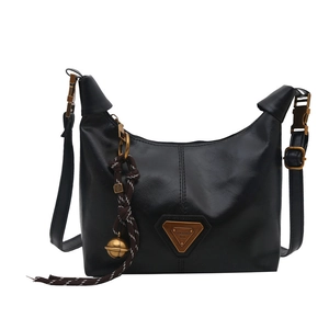 Vintage black faux leather shoulder bag with gold hardware and woven bell charm