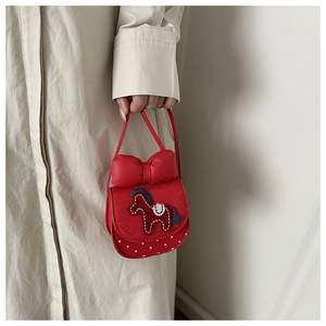 Detail of red mini crossbody bag with a cute horse embroidery and a leather bow