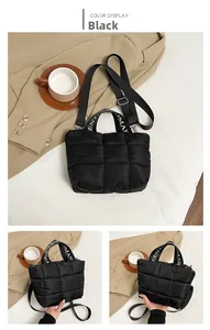 Close-up of black quilted puffer bag with signature Gentlewoman strap details