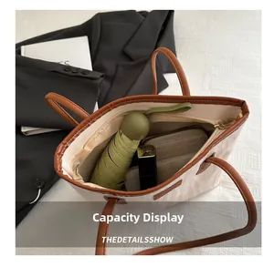 Detailed interior of a spacious beige tote bag showing space for umbrellas and wallets