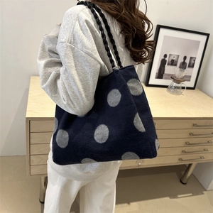 Winter plush tote bag in navy blue with grey polka dots and black woven strap