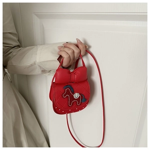 Detail of red quilted crossbody bag with 3D bow and pony embroidery for girls